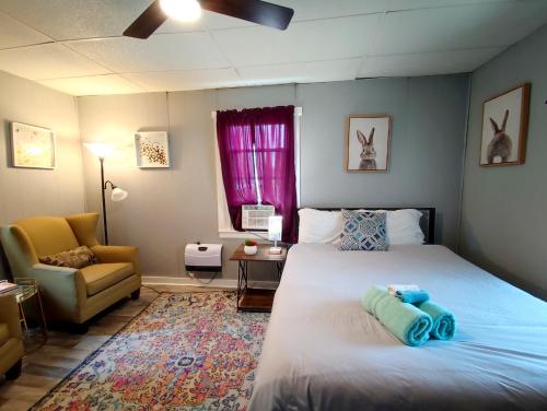 a bedroom with a bed and a couch and a chair at Perfect Combo of Charm & Comfort- 2Bedroom Home in Noblesville