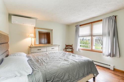 a bedroom with a bed and a window at Quaint Massachusetts Home with Yard and Grill! in Gill