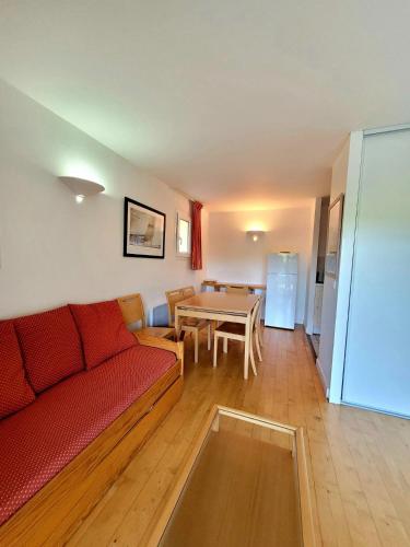 a living room with a couch and a table at Appartement n°75 : 4-6 personnes plages à pied in Capbreton