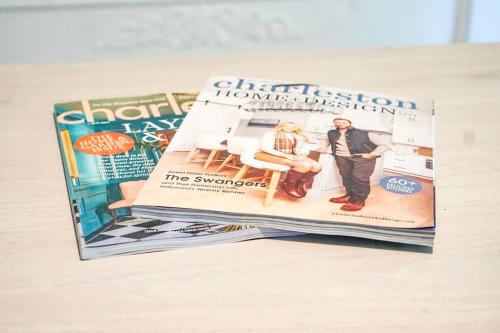 a stack of magazines sitting on a table at The Halcyon Days North Charleston in Charleston