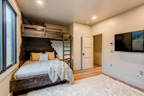 a bedroom with a bunk bed and a large window at Maynard V at Elk Creek in Banner Elk