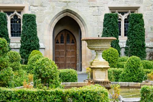 a vase in a garden in front of a building at Langley Castle Hotel in Hexham