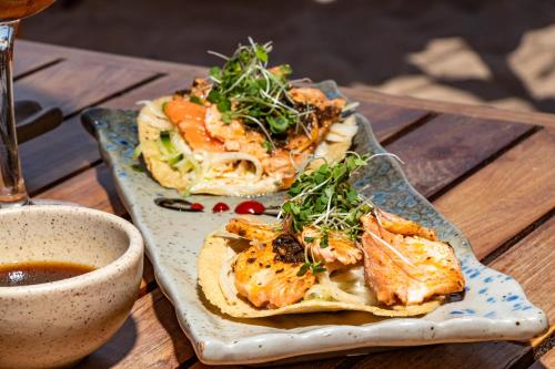 two plates of food on a table with a cup of coffee at HAU Holbox, Oceanfront Boutique Hotel in Holbox Island