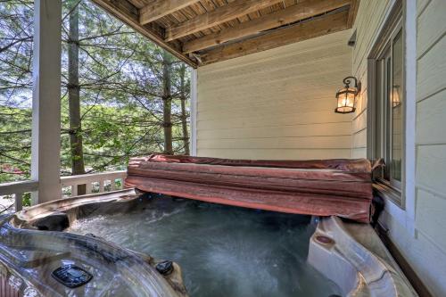 a hot tub on the porch of a house at Lillys Mountain Escape in Banner Elk