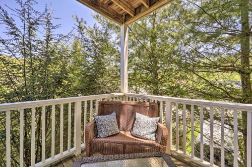a rocking chair on a porch with trees at Lillys Mountain Escape in Banner Elk