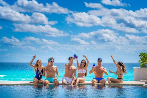 a group of people in the water at the beach at Sandos Cancún All Inclusive - Adults Only in Cancún