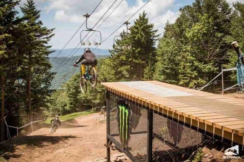 a person doing a trick on a bike on a lift at Close to Everything Ski In and Out in Snowshoe