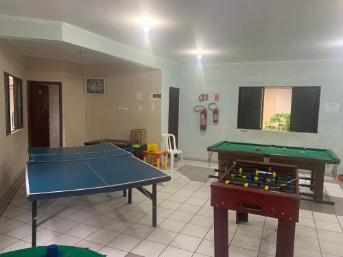 a living room with a ping pong table in it at Pousada D'Ibiza - Itanhaém in Itanhaém
