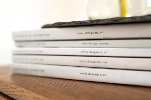 a stack of books sitting on a table at The Ballroom - Huge 2 Bed, Lichfield City Centre in Lichfield