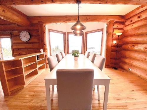 ein Esszimmer mit Tisch und Stühlen und einer Uhr in der Unterkunft Magical Retreat up to 20 People in St. Peter's