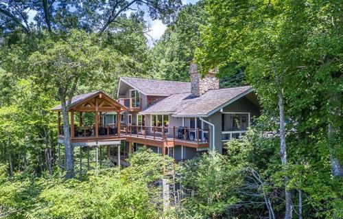 a large house in the middle of the forest at Hinesight at Hound Ears in Valle Crucis