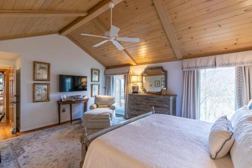 a bedroom with a bed and a ceiling fan at Hinesight at Hound Ears in Valle Crucis