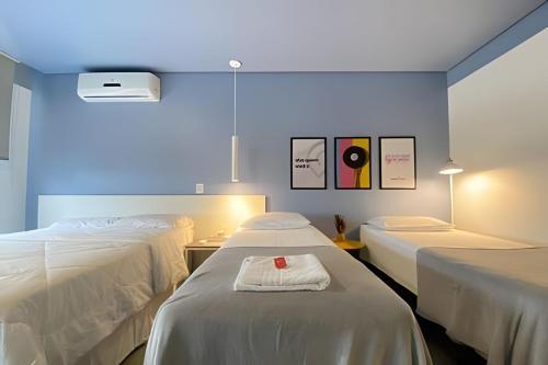 a hospital room with two beds and a blue light at Morcelli Mobiliados - Uniqo Smart Living in Santa Maria