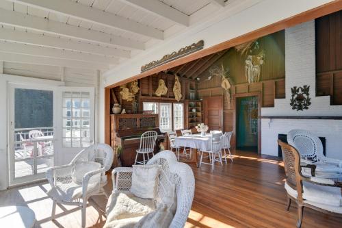 a living room with a table and chairs and a fireplace at Oceanfront Cottage with Deck 2 Mi to Boothbay Harbor in West Boothbay Harbor