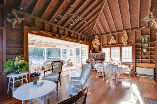 a dining room with wooden ceilings and tables and chairs at Oceanfront Cottage with Deck 2 Mi to Boothbay Harbor in West Boothbay Harbor