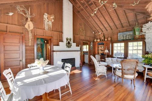a dining room with a table and chairs and a fireplace at Oceanfront Cottage with Deck 2 Mi to Boothbay Harbor in West Boothbay Harbor