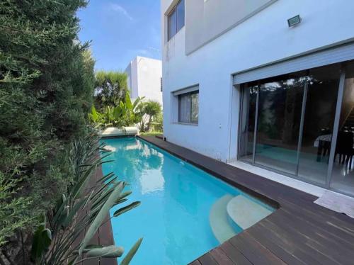 a swimming pool in front of a house at Villa de Luxe piscine privée in Casablanca