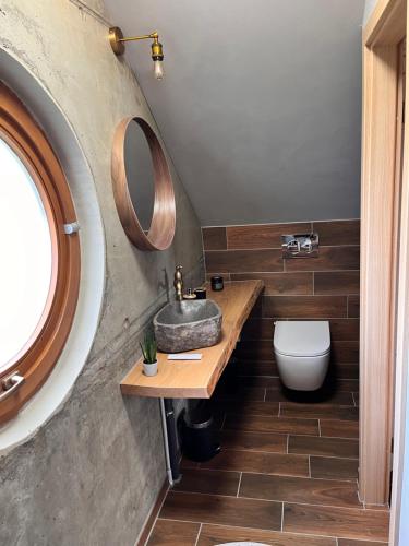 a bathroom with a sink and a toilet at Ferienhaus Katharina in Hoyerswerda