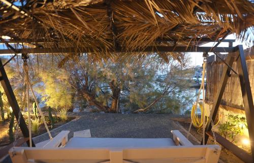 a swinging porch with a view of a river at Maistrali Studio Ostria in Parakopí