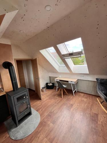 a living room with a stove and a table at Ferienhaus Katharina in Hoyerswerda