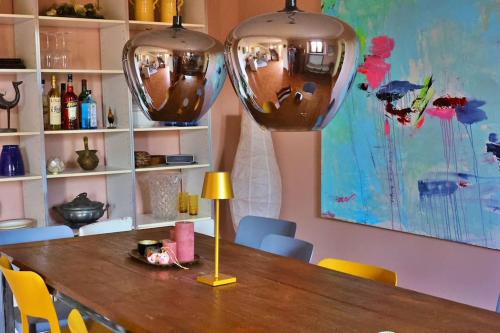 a dining room table with two large vases on top of it at Villa Rosella alt in Crespina