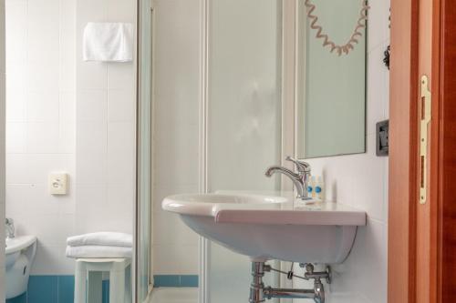 a bathroom with a sink and a shower at Hotel Touring in Falconara Marittima