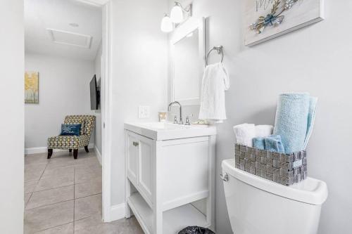 a white bathroom with a sink and a toilet at Annas Peaceful Retreat Luxury Suite in Fort Lauderdale