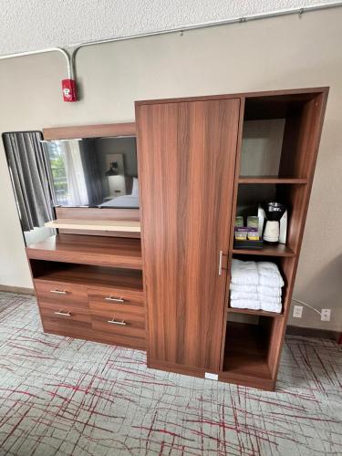 a large wooden cabinet in a room at Hawthorn Extended Stay by Wyndham Columbia-Ft Jackson in Columbia