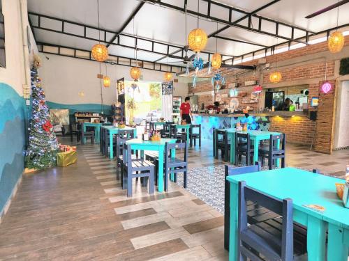 a dining room with blue tables and a christmas tree at Suite en Tlaquepaque centro in Guadalajara