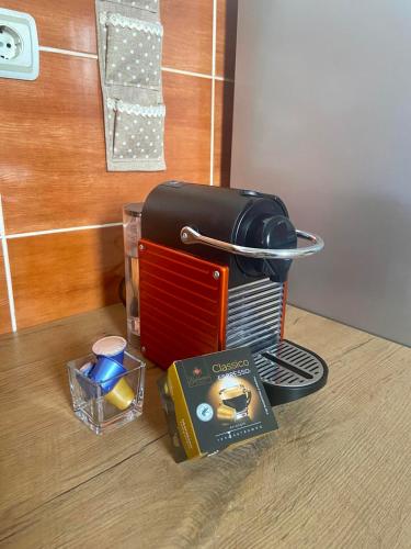 a table with a toaster and a box on it at City view & pool apartment in Niš