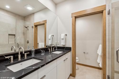 a bathroom with two sinks and a large mirror at Discover Luxury at Cantera 303 in Whitefish