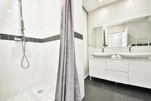 une salle de bain avec deux lavabos et une douche dans l'établissement Villa Luxueuse à Cavalaire-sur-Mer, à Cavalaire-sur-Mer