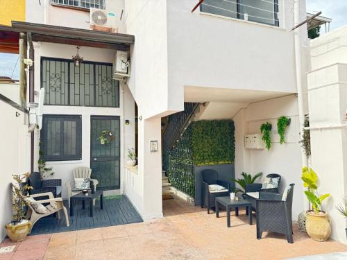 a patio with chairs and tables on a building at Tommy's Apartment in Pompei