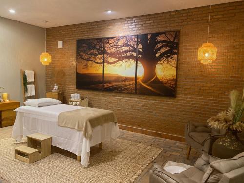 a bedroom with a large painting on the wall at Hotel Fazenda Santa Monica in Louveira