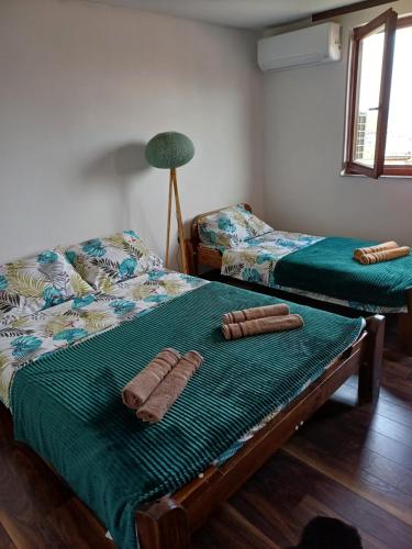 a room with two beds with towels on them at Himber Rooms in Sarajevo