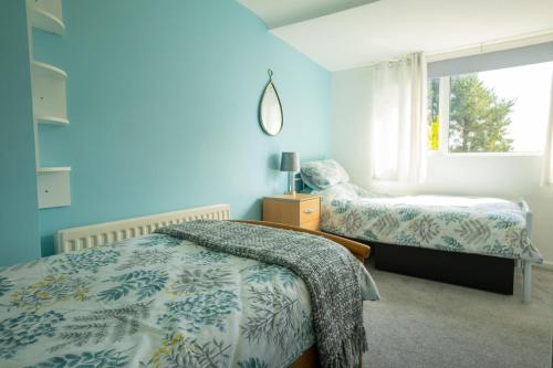 a bedroom with two beds and a window at Golf Links Cottage - Views of Royal County Down in Newcastle