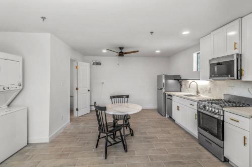 a white kitchen with a table and chairs in it at Studios on Fourth in McAllen