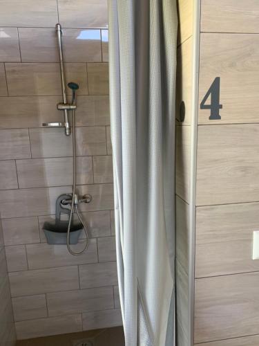 a bathroom with a shower with the number four at Kuća za odmor KRNJAIĆ in Bosanski Novi