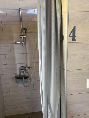a bathroom with a shower with the number four at Kuća za odmor KRNJAIĆ,porodični KAMP in Bosanski Novi