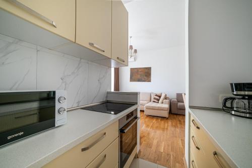 a kitchen with white counter tops and a stove top oven at The Dream Getaway & Spa by DeVasco in Becici