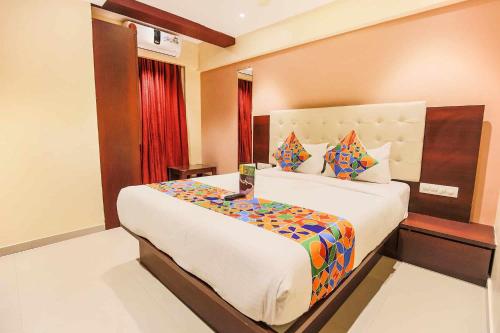 a bedroom with a large bed in a room at Hotel Golden At Delhi Airport in New Delhi