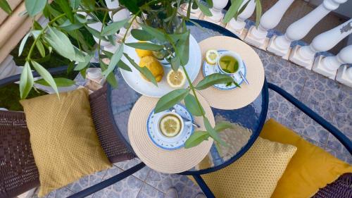 a glass table with two hats and cups on it at Apartments Arina in Krasici