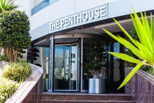 a building with the entrance to the perl house at The Penthouse Suites Hotel in Tunis