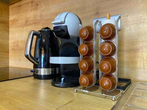 a coffee maker and a bunch of donuts on a counter at Mobile Home SkyLine - beautiful sea view - on the palm of the beach in Drage