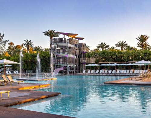 a swimming pool with a fountain in front of a building at Hyatt Regency Scottsdale Resort and Spa in Scottsdale