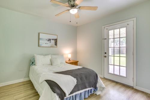 a bedroom with a bed and a ceiling fan at Centrally Located Gonzales Home with Yard! in Gonzales