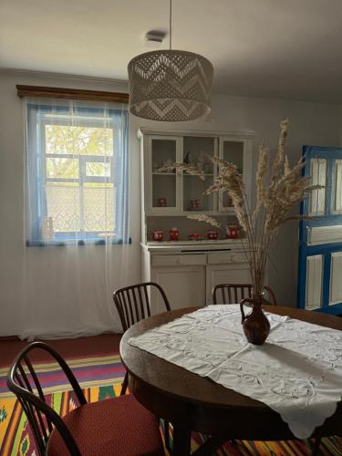 a kitchen with a table with a vase of flowers on it at Бабусина хатка in Leplyavo