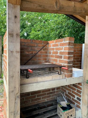 a brick wall with a bench on top of it at Kuća za odmor KRNJAIĆ,porodični KAMP in Bosanski Novi