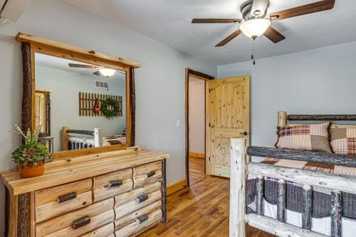 a bedroom with a bed and a dresser and a mirror at Family-Friendly Milton Home on 14 Acres with Hot Tub in Milton