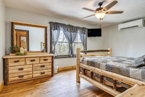 a bedroom with a bed and a dresser and a mirror at Family-Friendly Milton Home on 14 Acres with Hot Tub in Milton